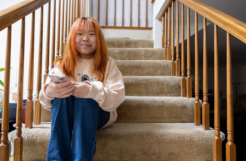 澳门正规博彩十大排行平台 patient sitting on her stairs.